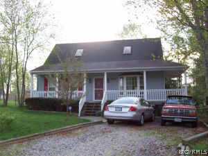 a front view of a house with a garden and porch