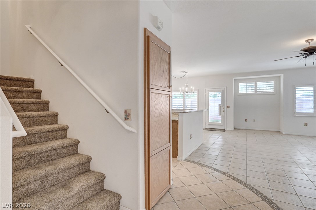 1479 Orange Jubilee Road Henderson, NV 89014 - Photo 4 of 36 A welcoming entryway transitions seamlessly into an open-concept living area with classic tiled flooring.