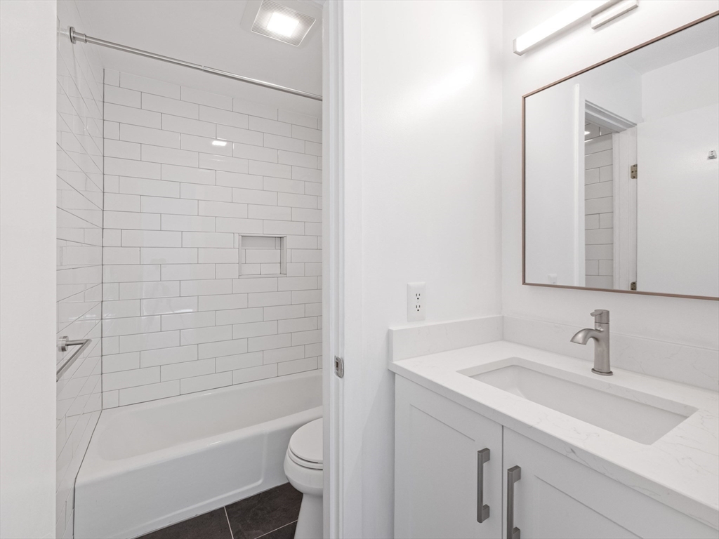 18 Concord Greene, Unit 6 Concord, MA 01742 - Photo 13 of 31 a bathroom with a sink a toilet and shower