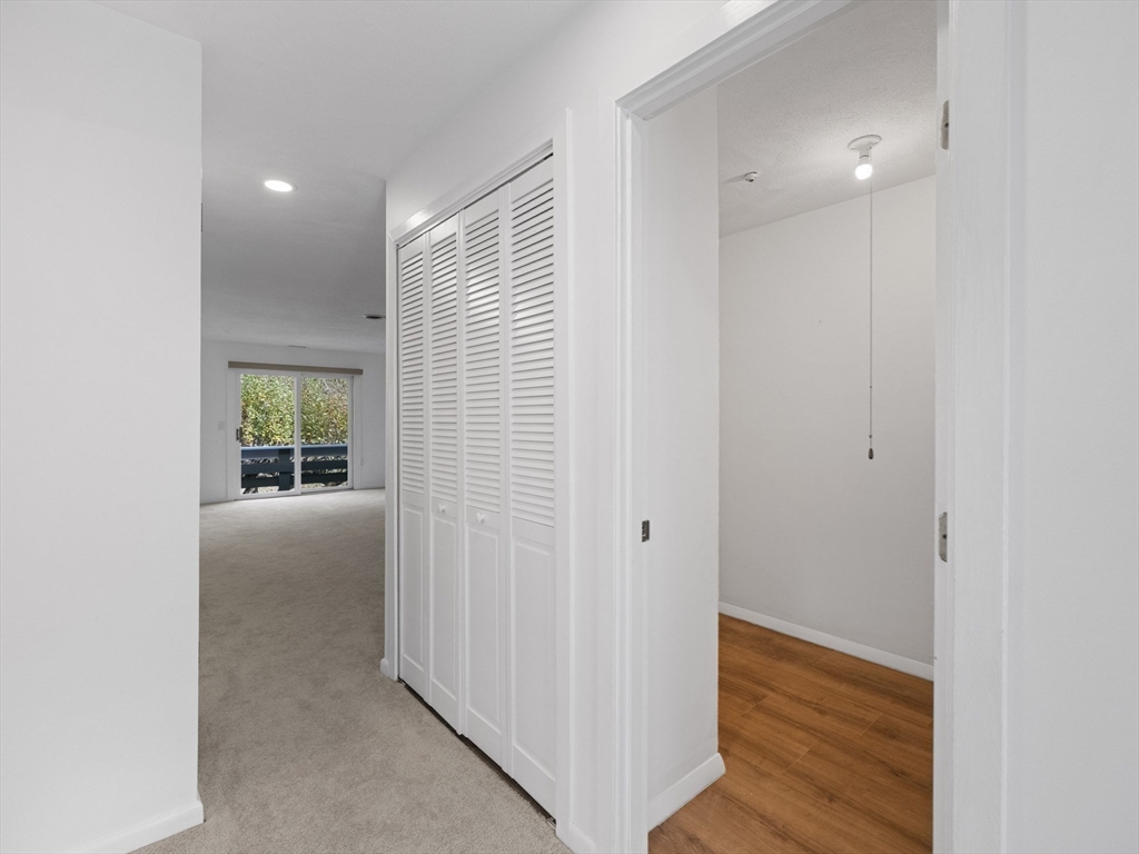 18 Concord Greene, Unit 6 Concord, MA 01742 - Photo 21 of 31 a view of hallway with wooden floor