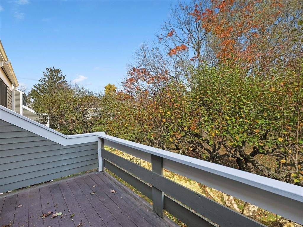 18 Concord Greene, Unit 6 Concord, MA 01742 - Photo 25 of 31 a view of balcony with wooden floor and fence