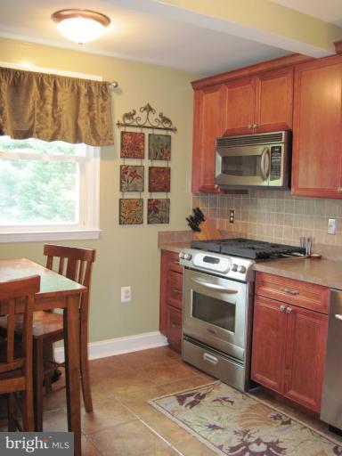 501 South Hammonds Ferry Road Linthicum Heights, MD 21090 - Photo 12 of 30 a kitchen with a stove a sink and a microwave