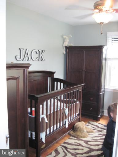 501 South Hammonds Ferry Road Linthicum Heights, MD 21090 - Photo 21 of 30 a bedroom with a bed and wooden floor