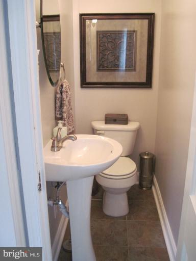 501 South Hammonds Ferry Road Linthicum Heights, MD 21090 - Photo 22 of 30 a bathroom with a toilet a sink and mirror