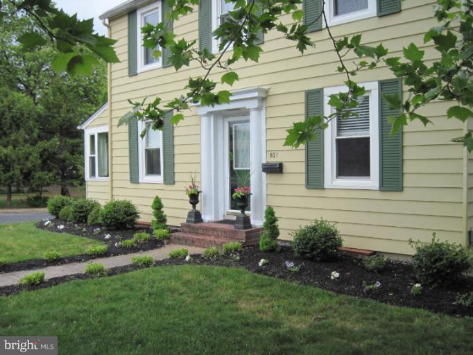 501 South Hammonds Ferry Road Linthicum Heights, MD 21090 - Photo 25 of 30 a view of a house with brick walls and a yard with plants