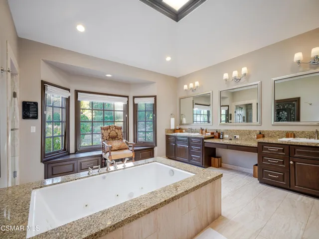 a large bathroom with a large tub and sink