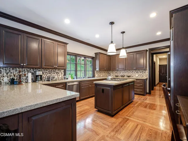 a kitchen with stainless steel appliances granite countertop a stove and a sink