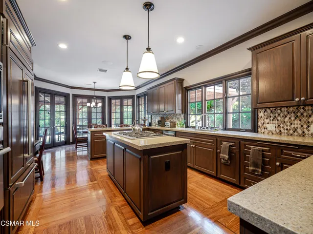 a view of a dining room with furniture a chandelier and window