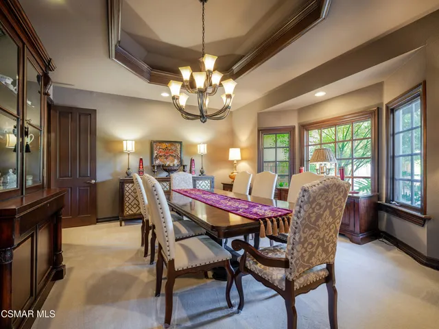 a bedroom with a bed flat screen tv and window