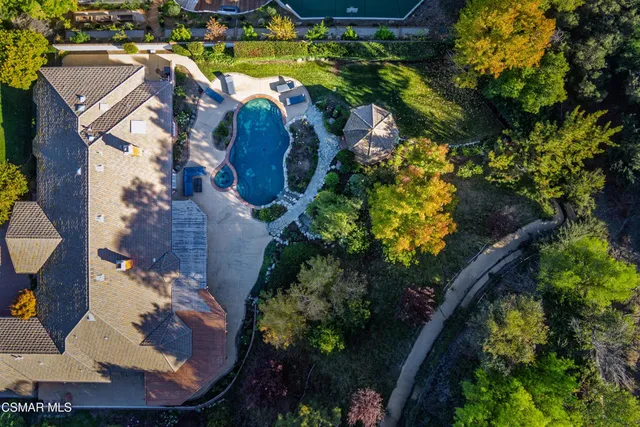 an aerial view of a house with garden space and a street view