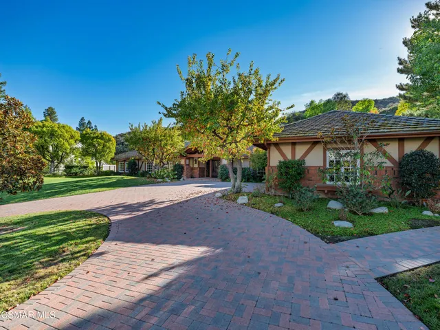 a front view of a house with a yard and a garage