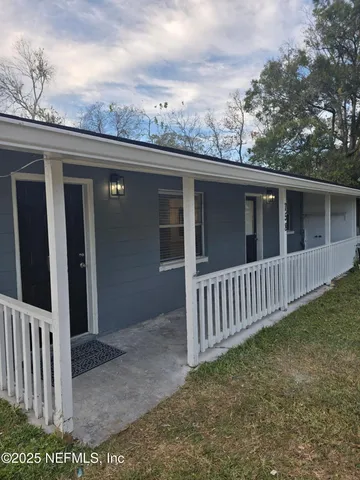 a view of a house with wooden fence