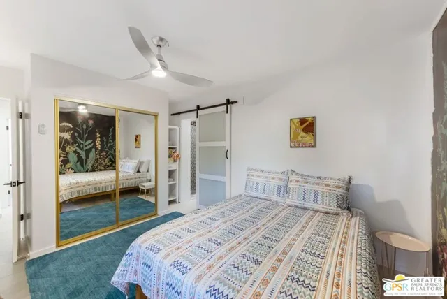 a bedroom with a bed and a dresser in it