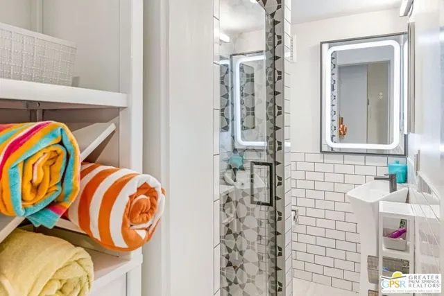 a bedroom with a bed and a book shelf