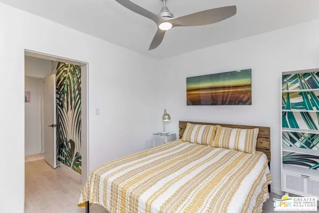 a bedroom with a bed and a painting on the wall