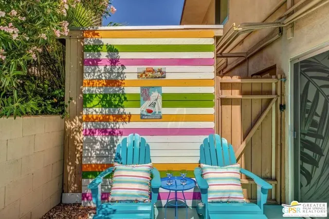a view of a swimming pool with outdoor seating