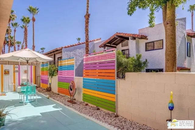 a view of a house with backyard sitting area and swimming pool
