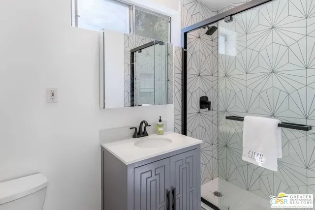 a bedroom with a bed dresser and a window