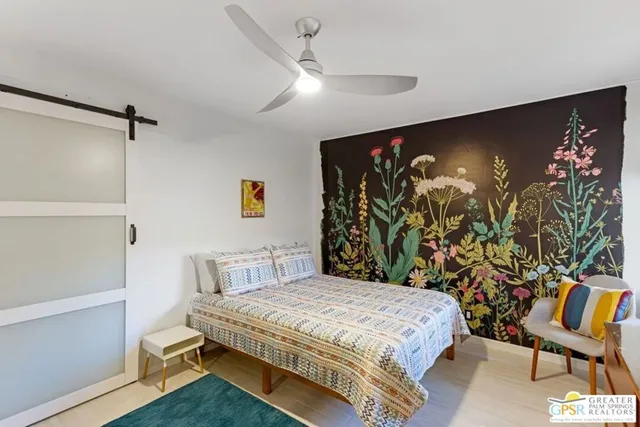 a bedroom with a bed and a glass door