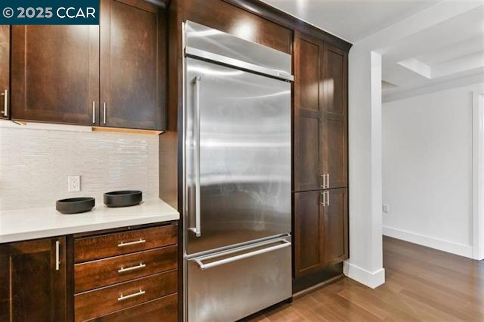 1000 Dewing Avenue, Unit 301 Lafayette, CA 94549 - Photo 12 of 20 a kitchen with a refrigerator and wooden cabinets