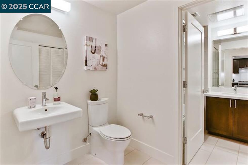1000 Dewing Avenue, Unit 301 Lafayette, CA 94549 - Photo 18 of 20 a bathroom with a sink toilet and mirror
