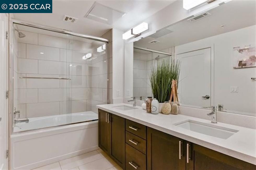1000 Dewing Avenue, Unit 301 Lafayette, CA 94549 - Photo 19 of 20 a bathroom with a double vanity sink mirror double and bathtub