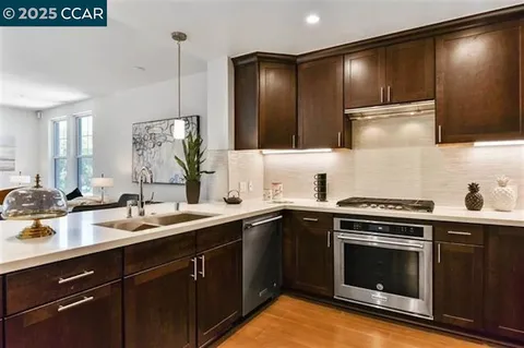 a kitchen with a sink stove and cabinets