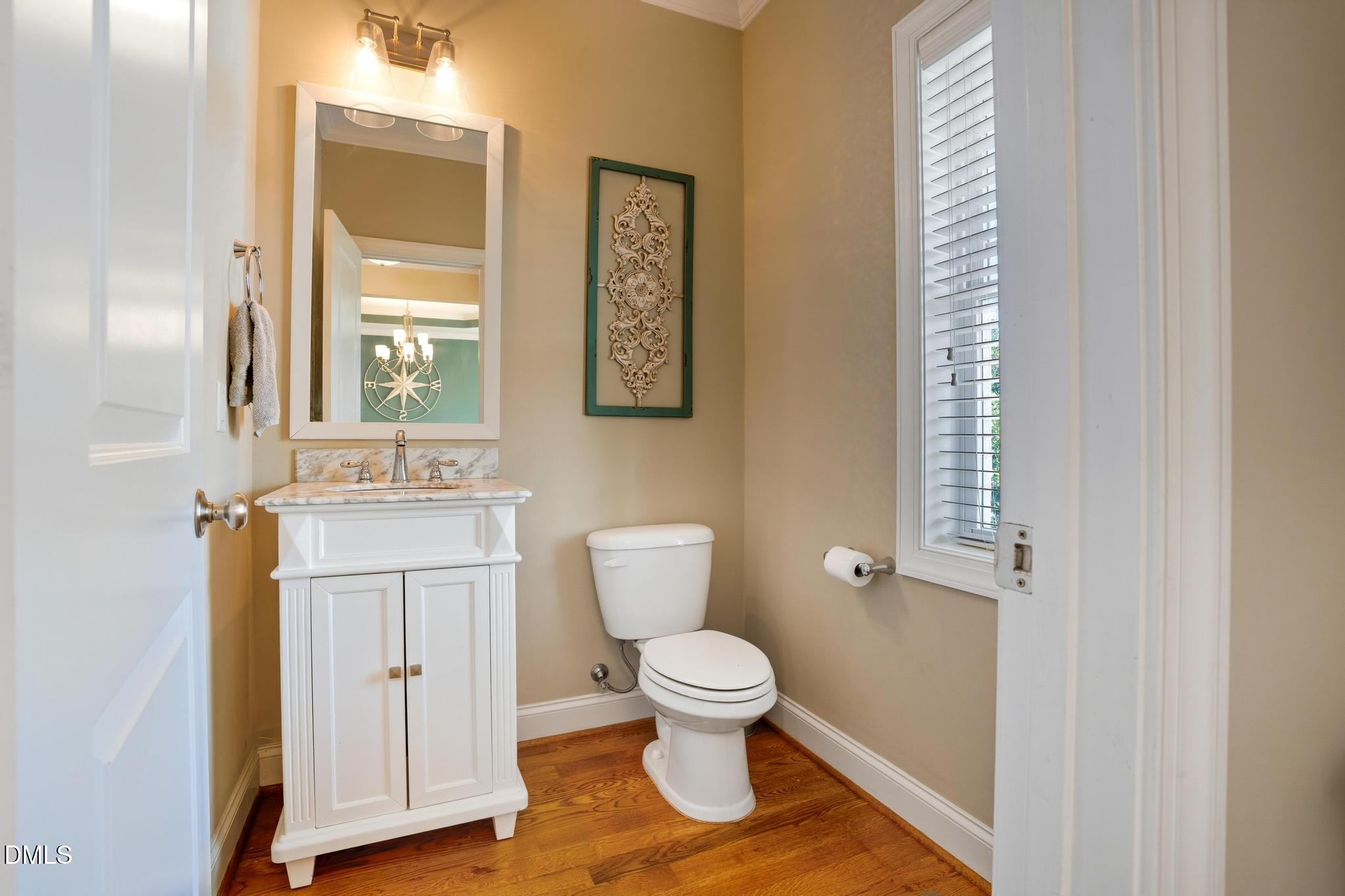 141 Vibernum View Four Oaks, NC 27524 - Photo 8 of 18 a bathroom with a toilet sink and a mirror