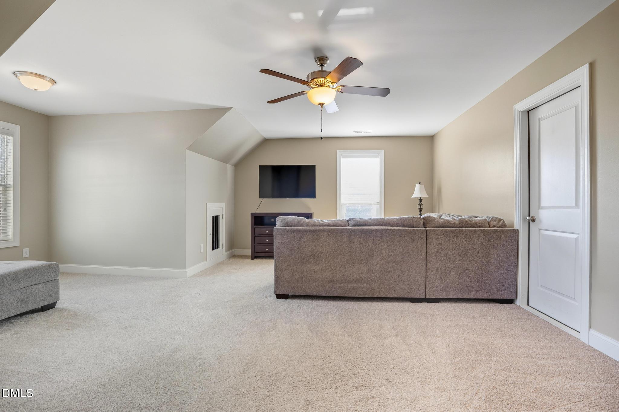 141 Vibernum View Four Oaks, NC 27524 - Photo 12 of 18 a living room with a couch a fireplace and a window