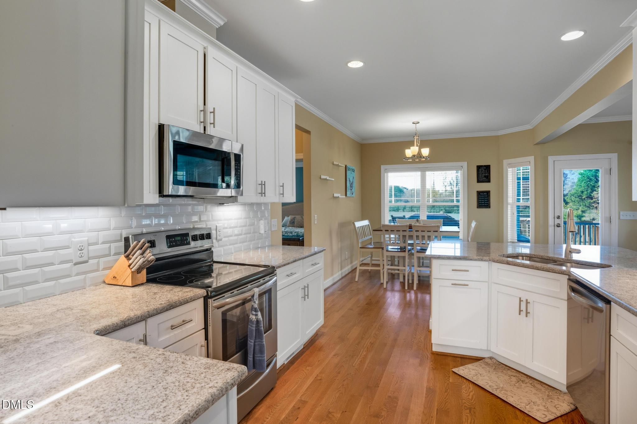 141 Vibernum View Four Oaks, NC 27524 - Photo 5 of 18 a kitchen with white cabinets and appliances