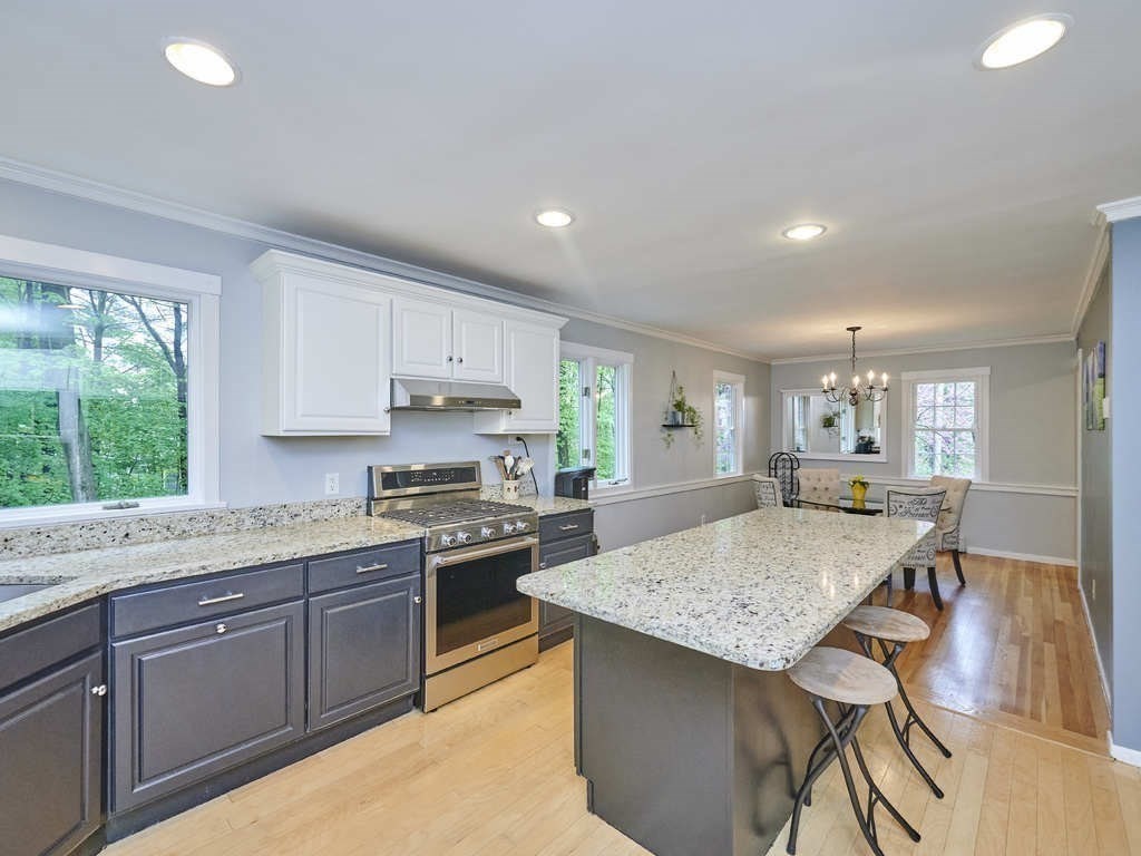 a kitchen with granite countertop kitchen island sink stove and granite counter top