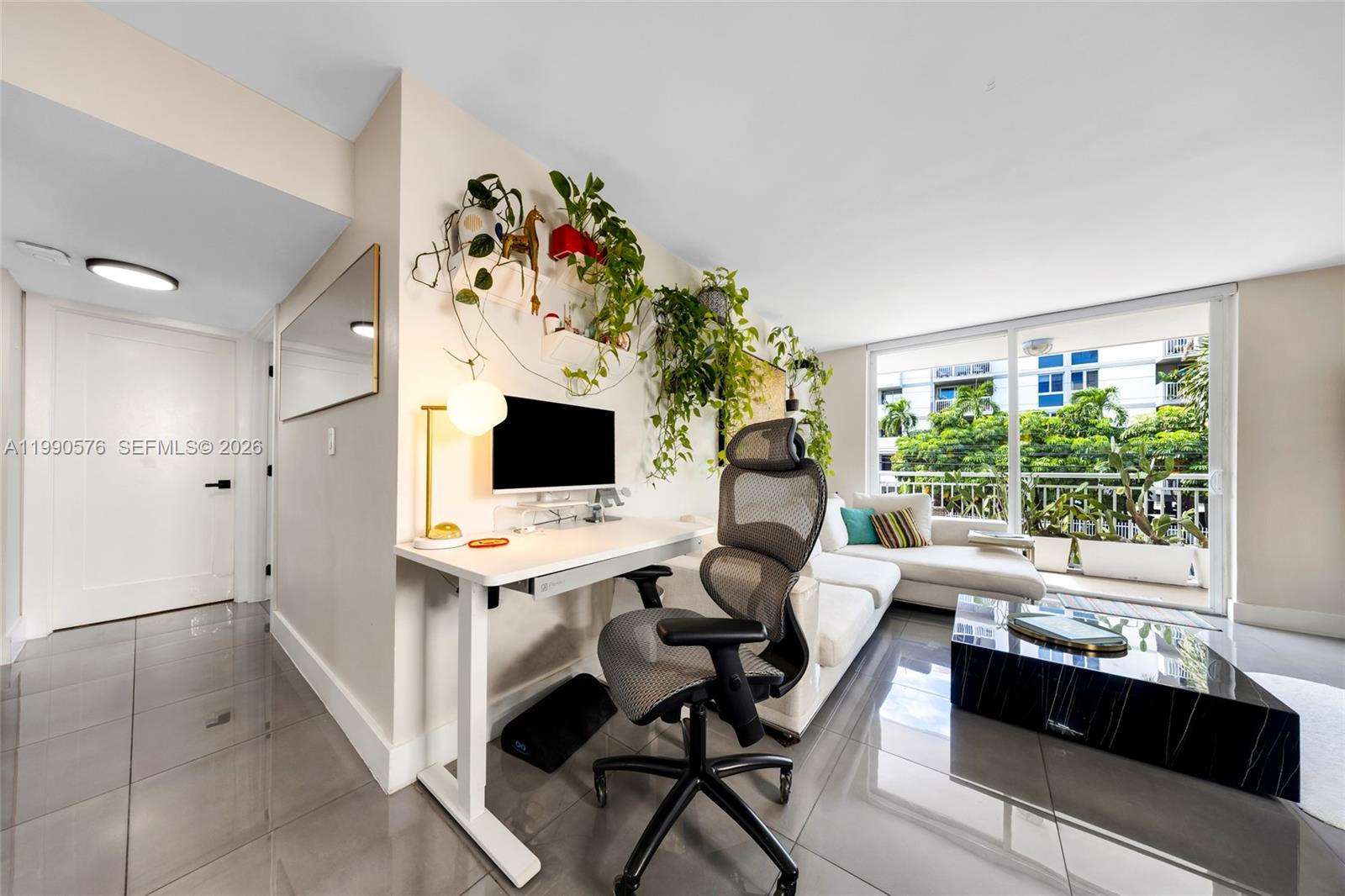 1665 Bay Road, Unit 221 Miami Beach, FL 33139 - Photo 14 of 33 a living room with furniture and a flat screen tv