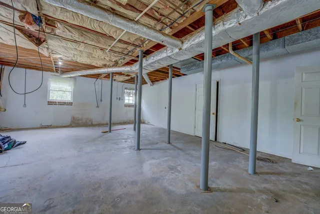 a view of a house with a yard and large trees