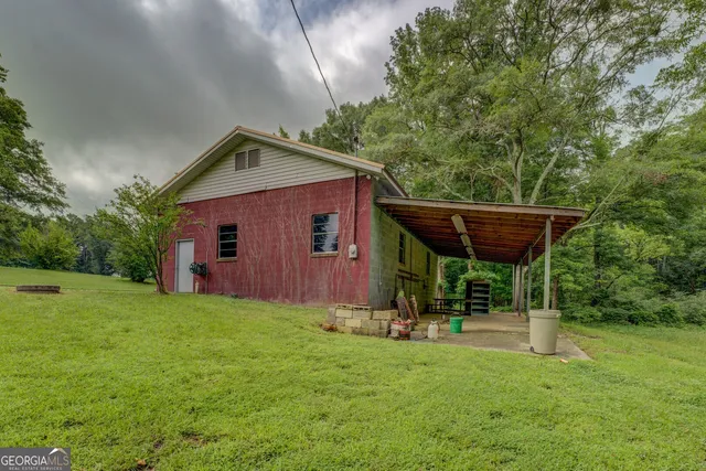 a backyard of a house with table and chairs