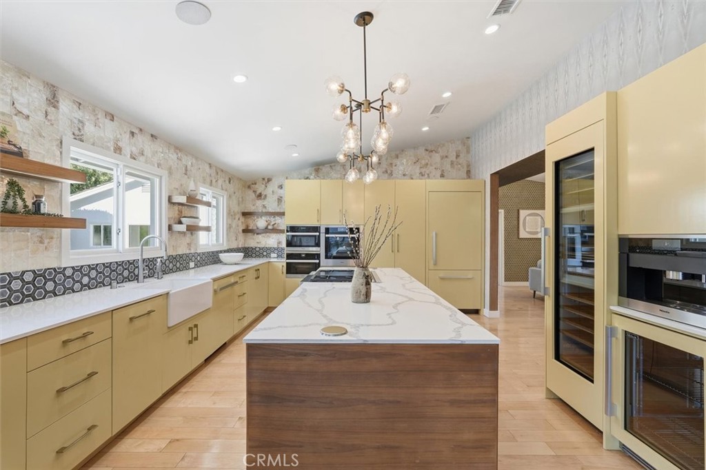 1205 Bryant Road Long Beach, CA 90815 - Photo 19 of 69 a large kitchen with granite countertop a large kitchen island and a sink