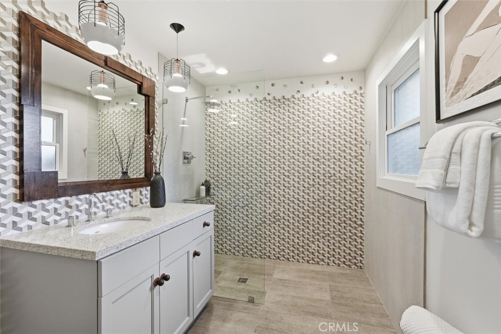 1205 Bryant Road Long Beach, CA 90815 - Photo 27 of 69 a bathroom with a sink a toilet and mirror