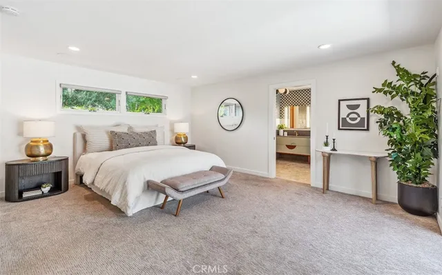 a living room with furniture a flat screen tv and a floor to ceiling window