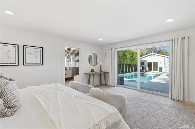 a bedroom with a large bed and a chandelier