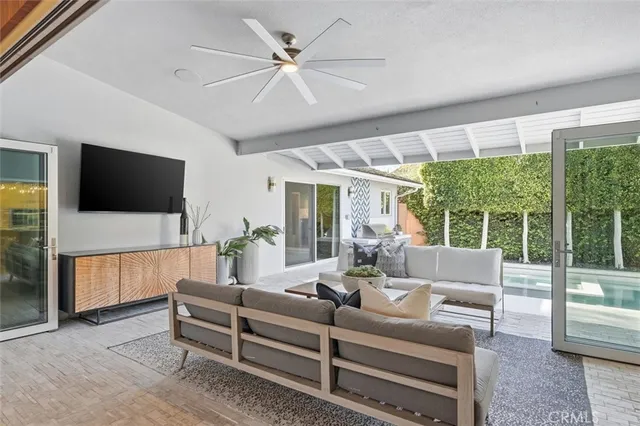 a view of a house with backyard porch and sitting area