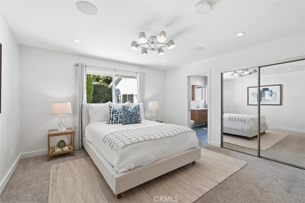 1205 Bryant Road Long Beach, CA 90815 - Photo 46 of 69 a bedroom with a large bed and a chandelier
