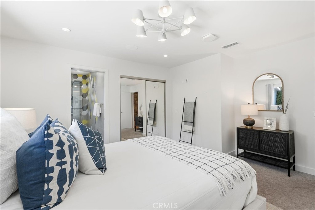 1205 Bryant Road Long Beach, CA 90815 - Photo 47 of 69 a bedroom with a bed and a chandelier