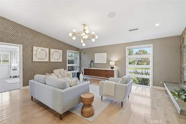 a living room with furniture potted plant and a large window