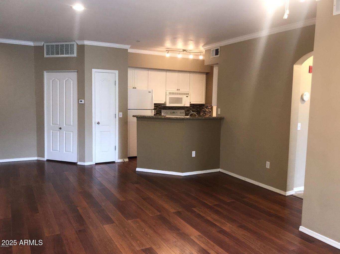 1701 East Colter Street, Unit 378 Phoenix, AZ 85016 - Photo 1 of 41 an empty room with wooden floor and window