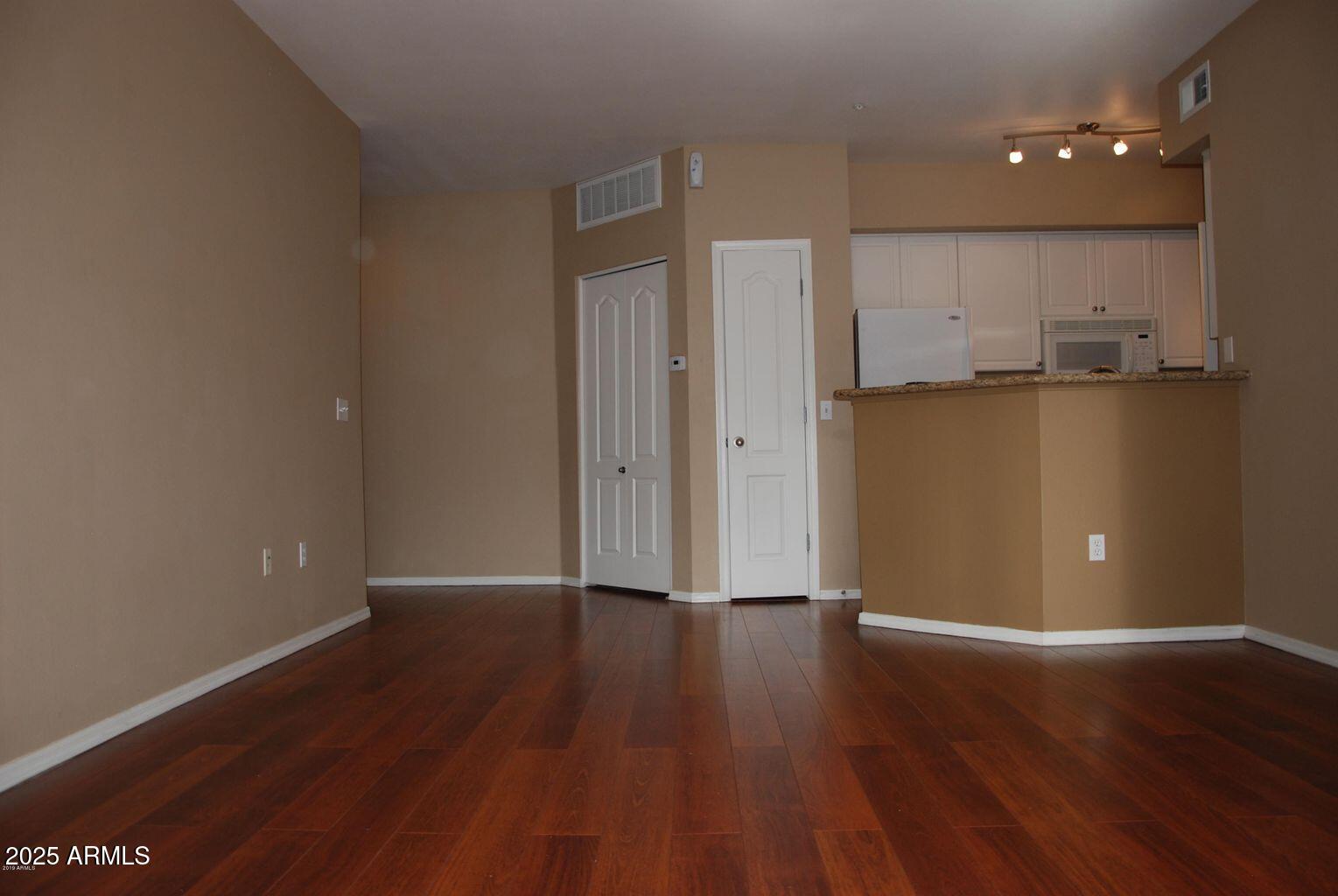 1701 East Colter Street, Unit 378 Phoenix, AZ 85016 - Photo 2 of 41 a view of a kitchen with a fridge and wooden floor