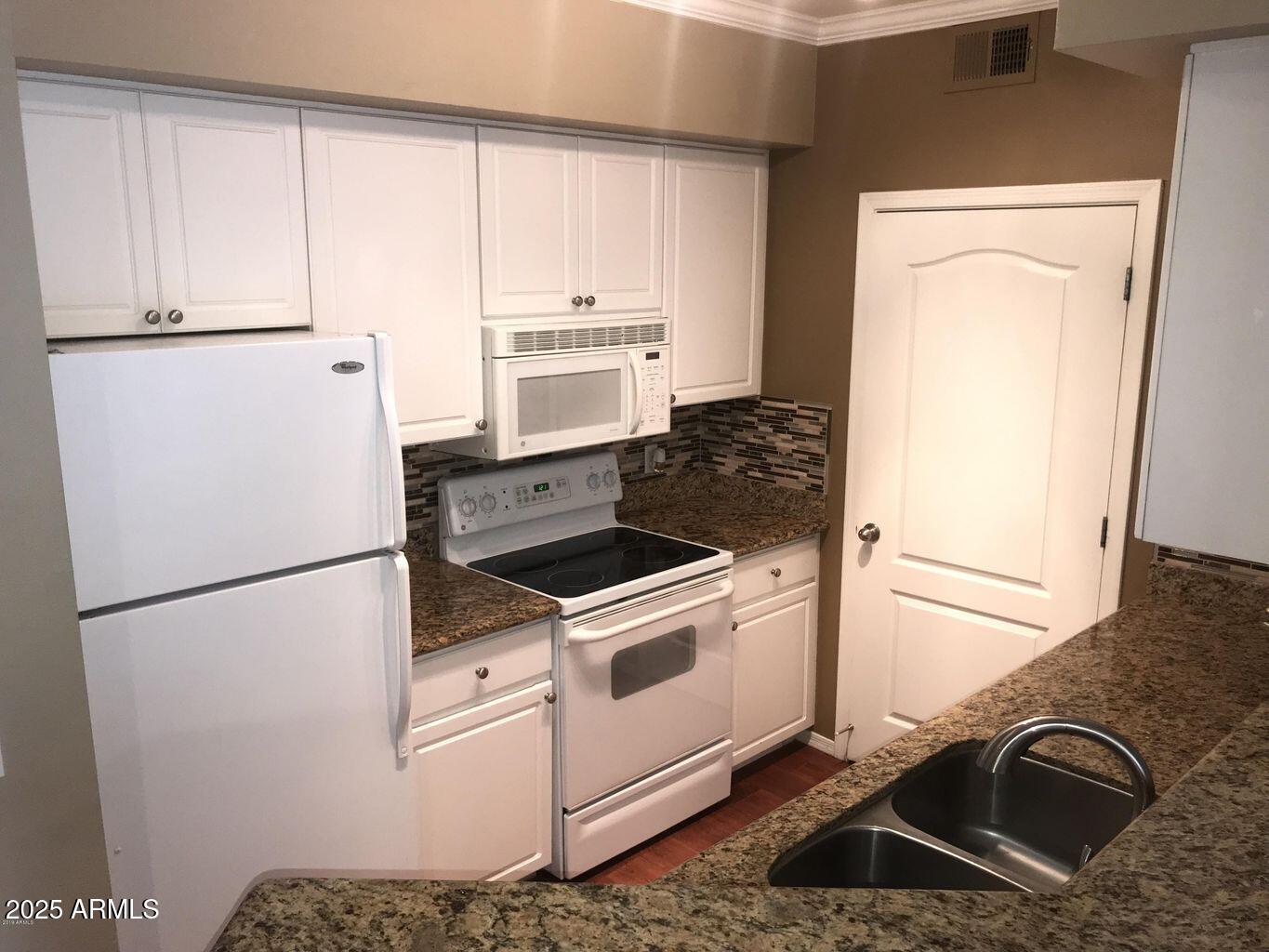 1701 East Colter Street, Unit 378 Phoenix, AZ 85016 - Photo 5 of 41 a white refrigerator freezer and a stove sitting inside of a kitchen
