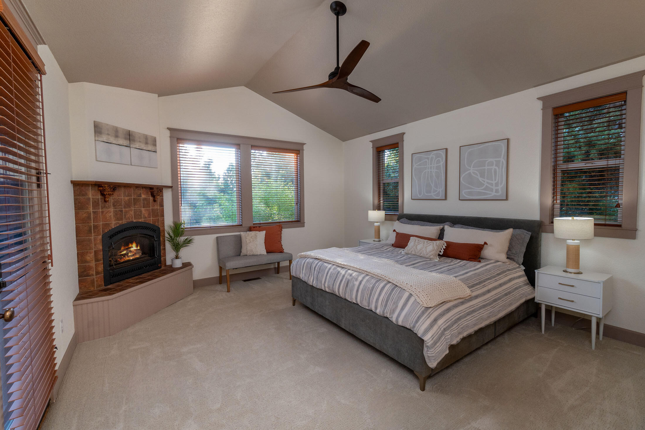 63475 Overtree Road Bend, OR 97701 - Photo 13 of 39 a bedroom with a bed couch and a fireplace
