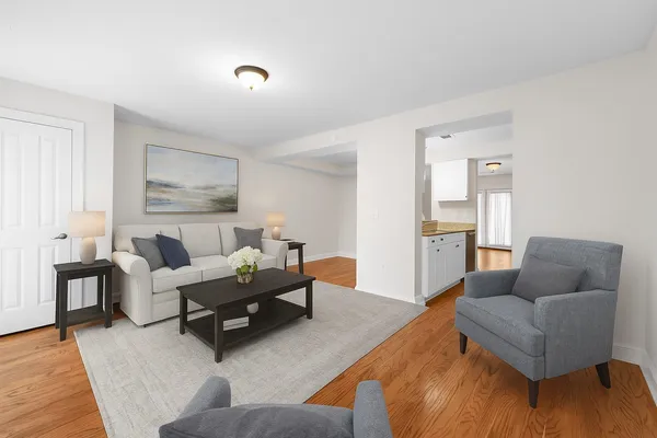 a view of empty room with wooden floor and white walls