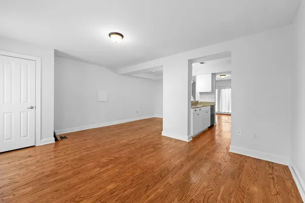 a large kitchen with stainless steel appliances granite countertop a lot of counter space and wooden floor