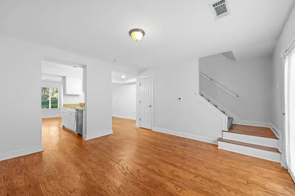 a view of empty room with wooden floor