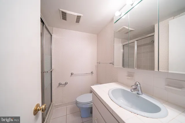 a bathroom with a glass shower door